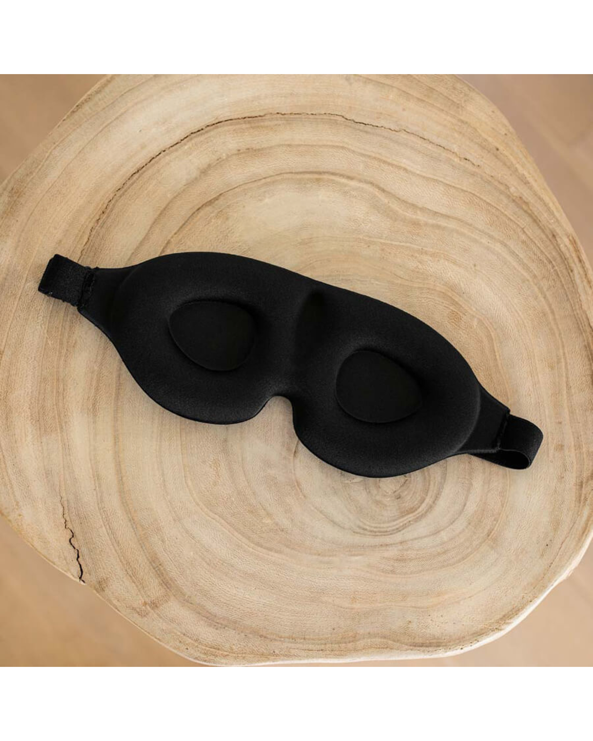 Interior view of a black sleep mask with contoured eye cups