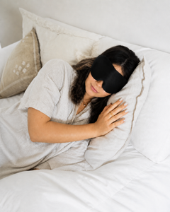 Woman sleeping on her side wearing the RestingBelly Sleep Mask