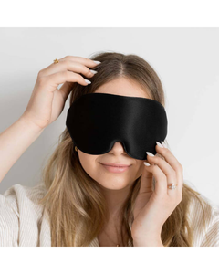 Front view of a black sleep mask being adjusted
