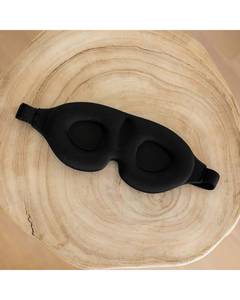 Interior view of a black sleep mask with contoured eye cups